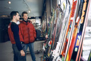 Carey Dodge looks for skis at the big sale, with the assistance of ski team member Mikai Staicu.