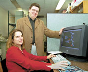 Professor Gilles Peslherbe and graduate student Denise Koch model chemical species on a workstation.