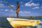 Islander men spear fishing.