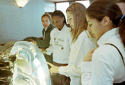 Visitors look at a model of an airplane engine turbine.