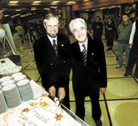 Photo of Garry Milton and Rector Lowy cutting the cake