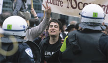 Riot police in front of students protesting