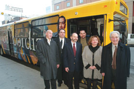 Photo of group in front of new bus