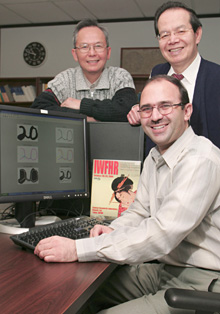 Professors Tien Bui and Ching Suen, with Javad Sadri in front