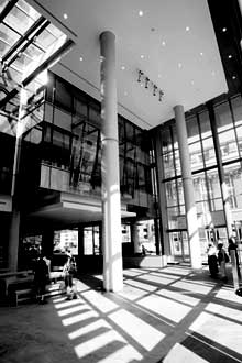 The main lobby of the building at Guy and Ste. Catherine Sts.is awash in sunlight. There are remarkable views of Montreal from the building on all sides, thanks to the glass walls.