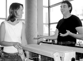 Loom with a view: Julie Simoneau, a third-year fibres student, talks with Bill Vorn, interim chair of Studio Arts, in a loom room high above the streets of downtown Montreal in the new Integrated Engineering, Computer Science and Visual Arts Complex. Simoneau is working as an assistant this summer as the Fibres program sets up in its new spaces, which include well-ventilated areas for the use of dyes. 