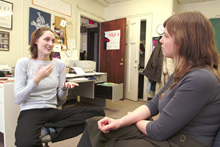 Bonita Squires, at left, signs with deaf office mate Pamela Witcher.