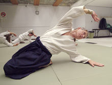 James Gavin stretches at the beginning of his aikido class.