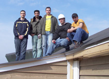 Solar Decathlon team members Tarek Ghazzaoui, Robert Moussa, Mark Pasini, Adrian Armorer and Saad Sakir on the roof of the house.